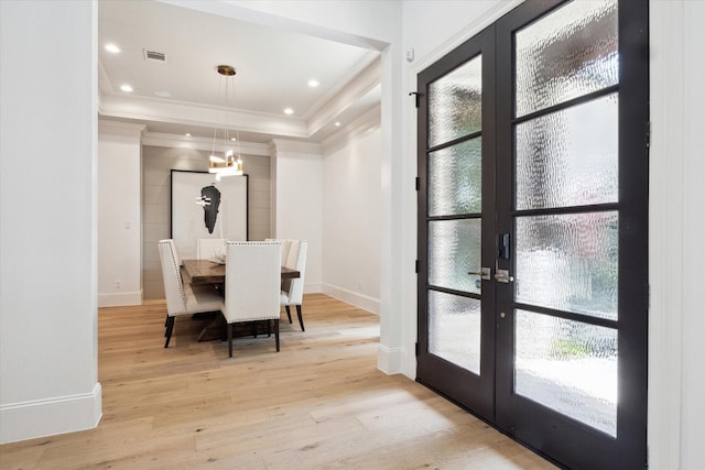 5202 Carew St, Houston, TX 77096 - dining room featuring french doors, crown molding, light wood-style floors, healthy amount of natural light, and baseboards