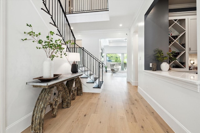5202 Carew St, Houston, TX 77096 - entryway featuring stairs, light wood-style floors, crown molding, baseboards, and recessed lighting