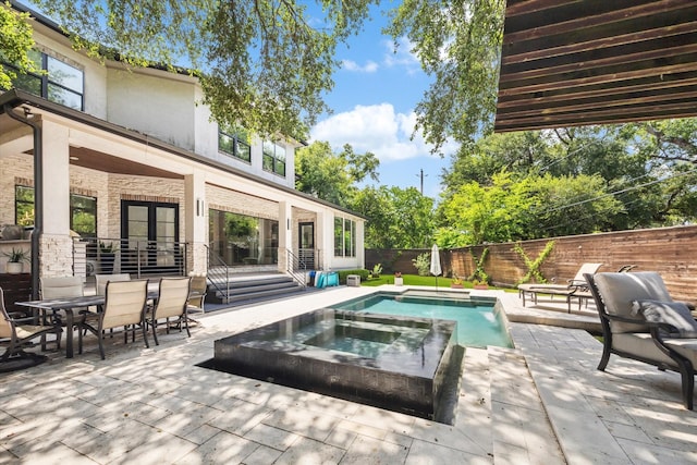5202 Carew St, Houston, TX 77096 - view of swimming pool with an in-ground hot tub, a fenced backyard, a patio, and outdoor dining space