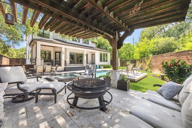 5202 Carew St, Houston, TX 77096 - fenced backyard featuring an in-ground hot tub, a patio, and outdoor dining space