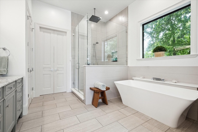 5202 Carew St, Houston, TX 77096 - full bathroom featuring a stall shower, a freestanding tub, vanity, and recessed lighting