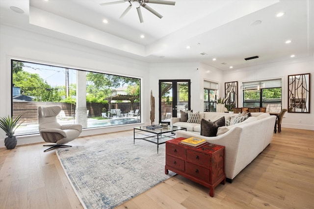 5202 Carew St, Houston, TX 77096 - living area featuring light wood-type flooring, ceiling fan, recessed lighting, a raised ceiling, and baseboards