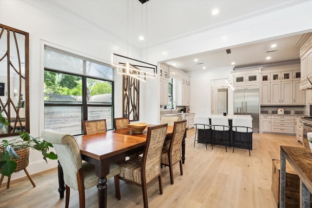 5202 Carew St, Houston, TX 77096 - dining area featuring light wood-style flooring, ornamental molding, recessed lighting, and a chandelier
