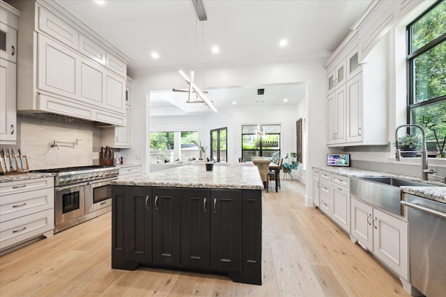 5202 Carew St, Houston, TX 77096 - kitchen with stainless steel appliances, a sink, healthy amount of natural light, recessed lighting, and light wood-style floors