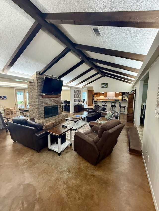 563 12th St, Bay City, TX 77414 - living area featuring a textured ceiling, concrete floors, a fireplace, and baseboards