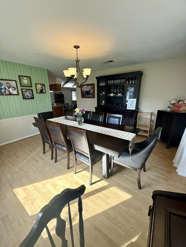 563 12th St, Bay City, TX 77414 - bar area featuring a chandelier, light wood-type flooring, and decorative light fixtures