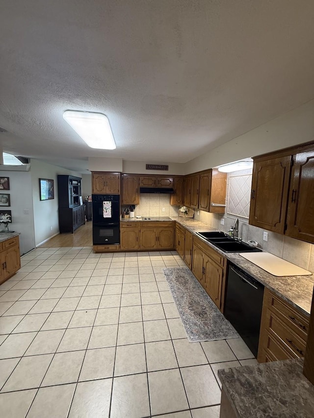 563 12th St, Bay City, TX 77414 - kitchen with a sink, black appliances, tasteful backsplash, light tile patterned floors, and a textured ceiling
