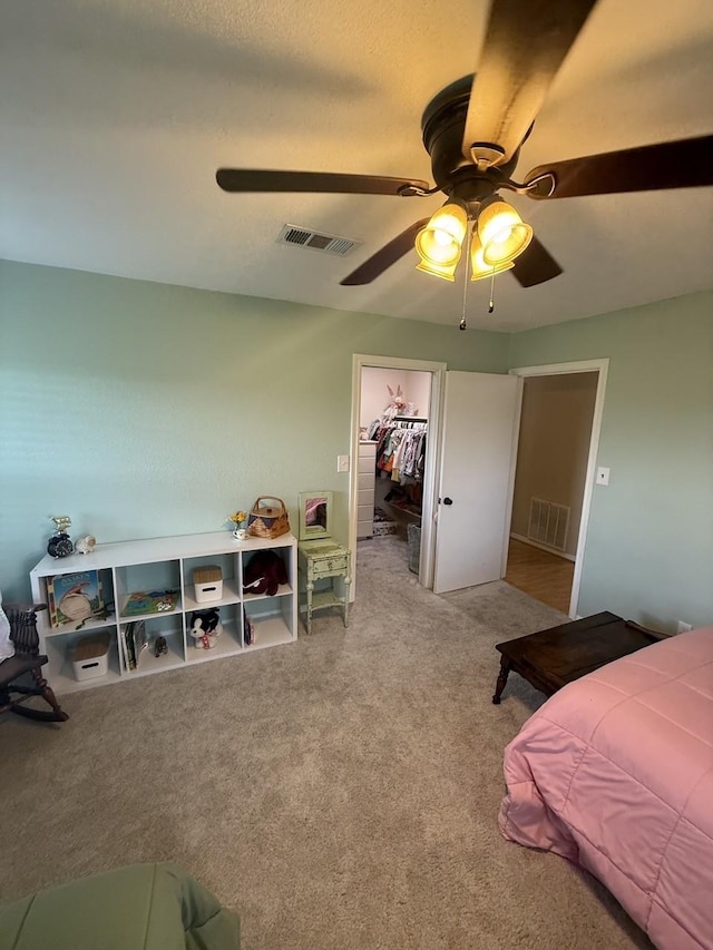 563 12th St, Bay City, TX 77414 - carpeted bedroom featuring a ceiling fan, a spacious closet, and a closet