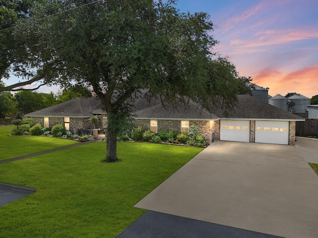563 12th St, Bay City, TX 77414 - ranch-style house featuring concrete driveway, a garage, and a yard