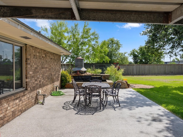 563 12th St, Bay City, TX 77414 - fenced backyard with a patio area and outdoor dining area