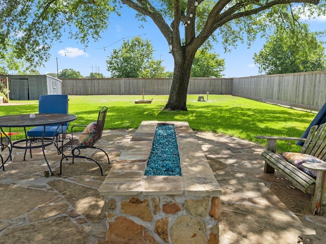 563 12th St, Bay City, TX 77414 - fenced backyard featuring a patio, a storage shed, and outdoor dining area