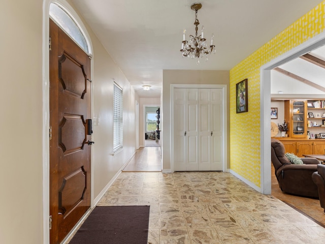 563 12th St, Bay City, TX 77414 - foyer featuring wallpapered walls and a chandelier