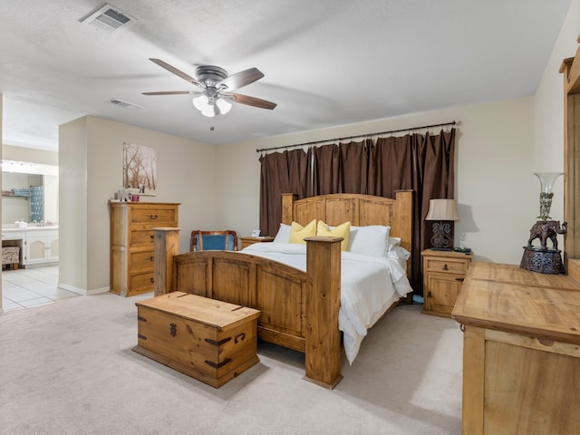 563 12th St, Bay City, TX 77414 - bedroom featuring light carpet, ceiling fan, and connected bathroom
