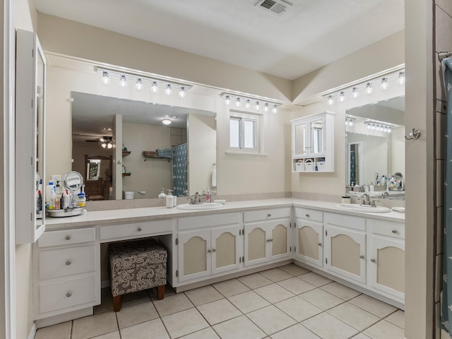 563 12th St, Bay City, TX 77414 - full bathroom featuring double vanity, tile patterned flooring, a shower with curtain, and ceiling fan