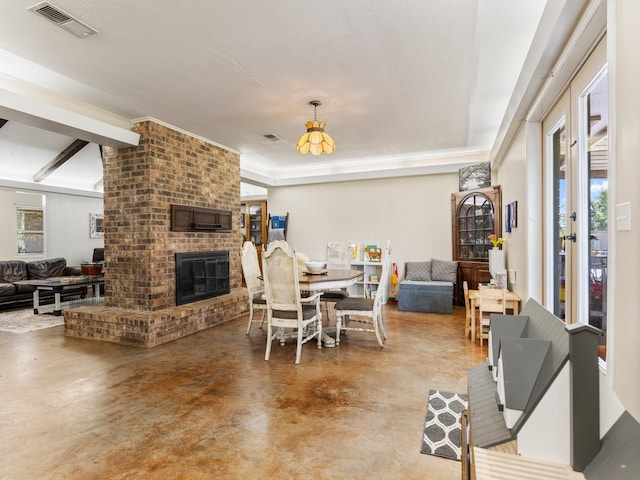 563 12th St, Bay City, TX 77414 - dining room featuring concrete floors and a brick fireplace