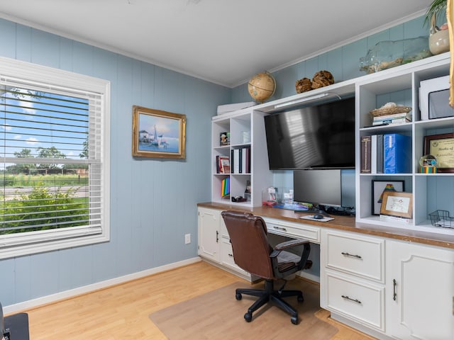 563 12th St, Bay City, TX 77414 - home office with built in desk, light wood-type flooring, and crown molding