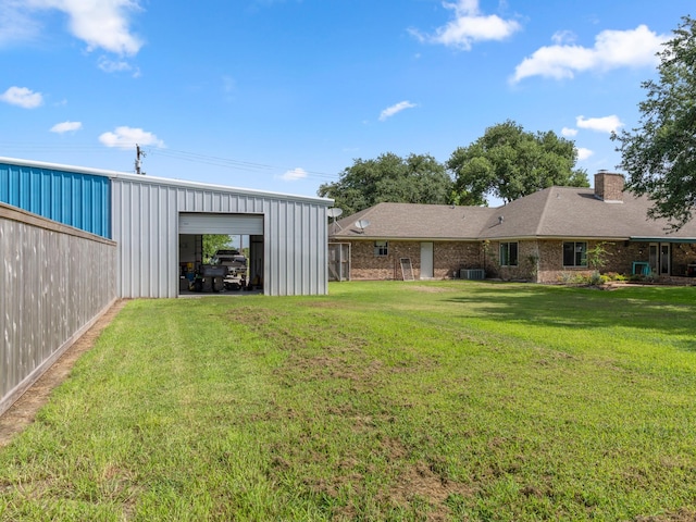 563 12th St, Bay City, TX 77414 - view of green lawn with a detached garage, an outdoor structure, and an outbuilding