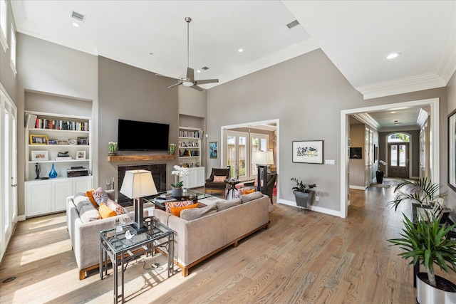 40 E Broad Oaks Dr, Houston, TX 77056 - living room featuring built in features, crown molding, a ceiling fan, baseboards, and light wood-style floors
