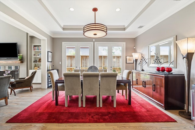 40 E Broad Oaks Dr, Houston, TX 77056 - dining space with ornamental molding, light wood-style floors, a raised ceiling, built in shelves, and recessed lighting
