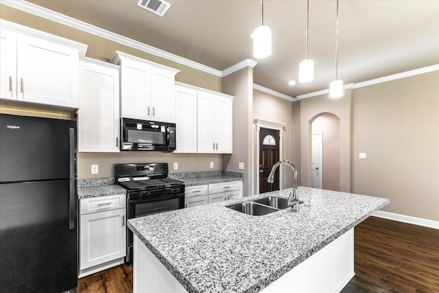 6514 Arabella, Houston, TX 77091 - kitchen featuring black appliances, a sink, arched walkways, dark wood-style flooring, and a kitchen island with sink