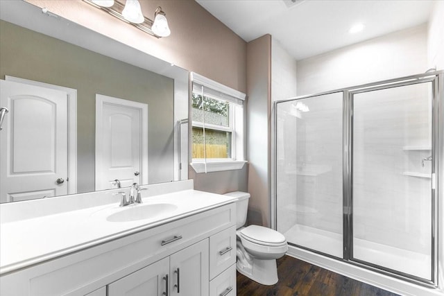 6514 Arabella, Houston, TX 77091 - bathroom featuring a shower stall, toilet, vanity, and wood finished floors