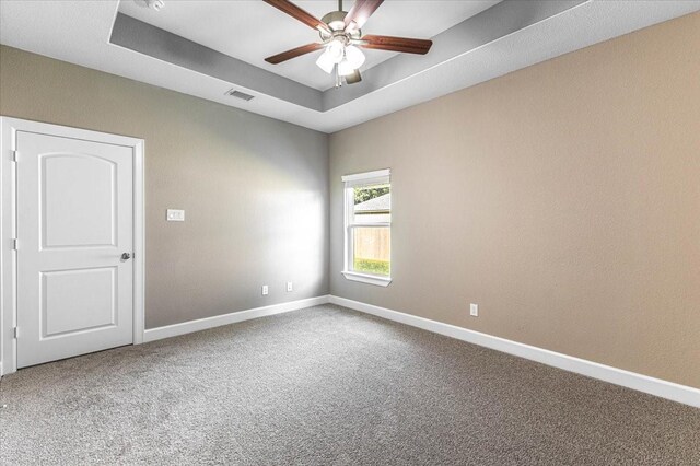 6514 Arabella, Houston, TX 77091 - spare room with carpet flooring, baseboards, a ceiling fan, and a tray ceiling