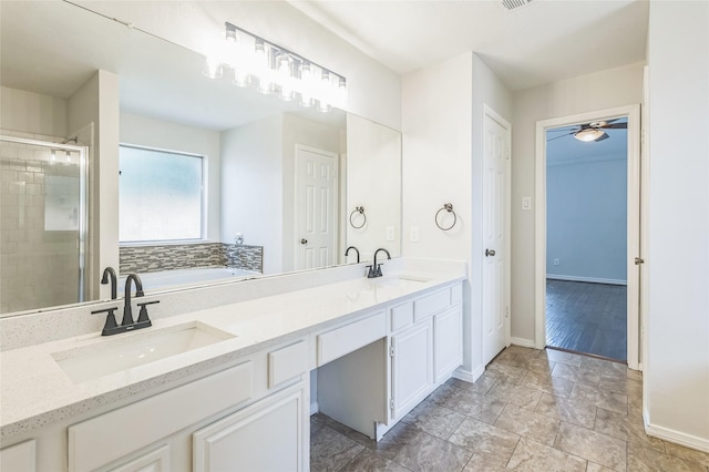 12023 Thornburg Ln, Houston, TX 77067 - bathroom featuring a garden tub, double vanity, a shower stall, baseboards, and a ceiling fan