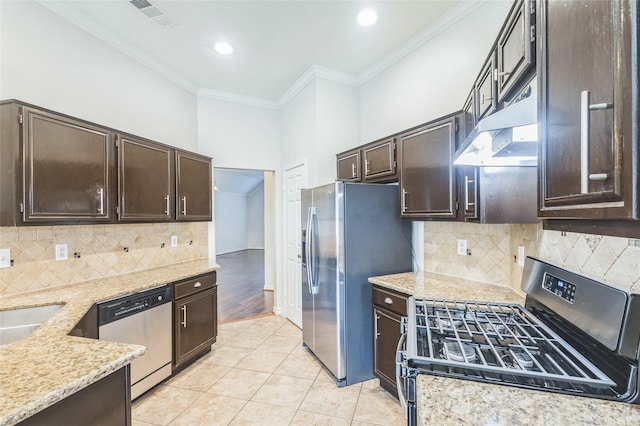 12023 Thornburg Ln, Houston, TX 77067 - kitchen featuring appliances with stainless steel finishes, crown molding, dark brown cabinets, light stone countertops, and light tile patterned flooring