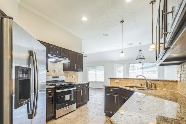 12023 Thornburg Ln, Houston, TX 77067 - kitchen featuring stainless steel appliances, a sink, tasteful backsplash, dark brown cabinetry, and light tile patterned floors