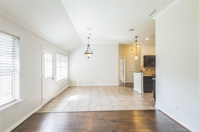 12023 Thornburg Ln, Houston, TX 77067 - unfurnished room with crown molding, light wood-type flooring, vaulted ceiling, and baseboards