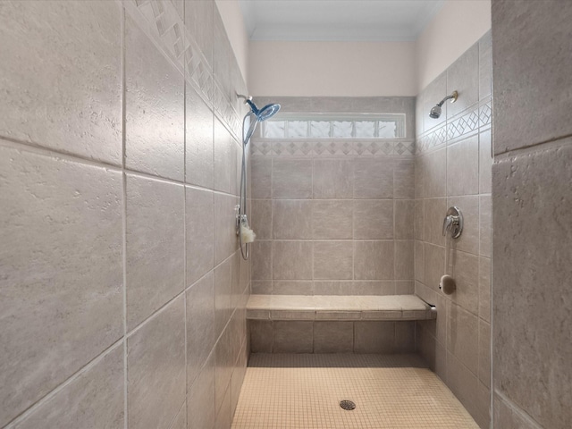 502 Westerly Dr, Tiki Island, TX 77554 - bathroom featuring a tile shower and ornamental molding