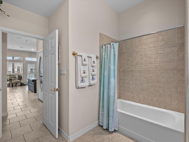 502 Westerly Dr, Tiki Island, TX 77554 - bathroom with tile patterned floors, baseboards, and shower / bath combo with shower curtain