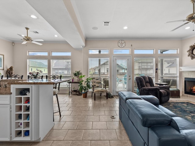 502 Westerly Dr, Tiki Island, TX 77554 - living room with ceiling fan, crown molding, a fireplace, recessed lighting, and light tile patterned floors