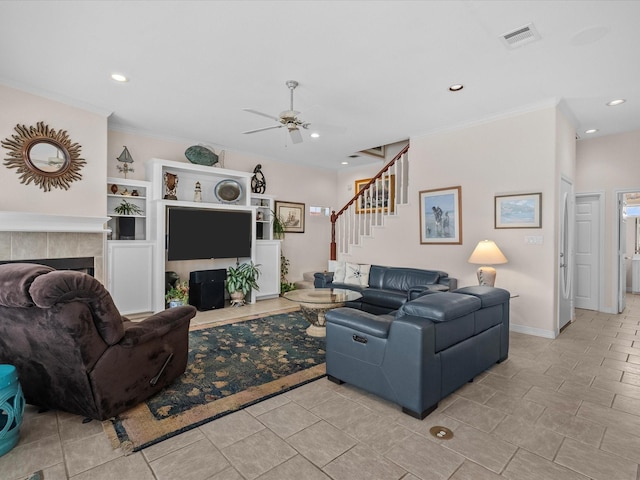 502 Westerly Dr, Tiki Island, TX 77554 - living area featuring ornamental molding, ceiling fan, a tile fireplace, recessed lighting, and stairs