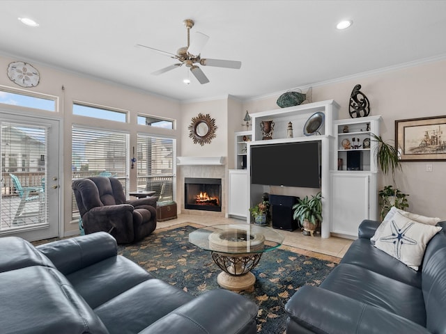 502 Westerly Dr, Tiki Island, TX 77554 - living area featuring a tiled fireplace, ornamental molding, a ceiling fan, tile patterned floors, and recessed lighting