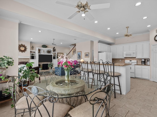 502 Westerly Dr, Tiki Island, TX 77554 - dining area with a ceiling fan, recessed lighting, stairs, and crown molding