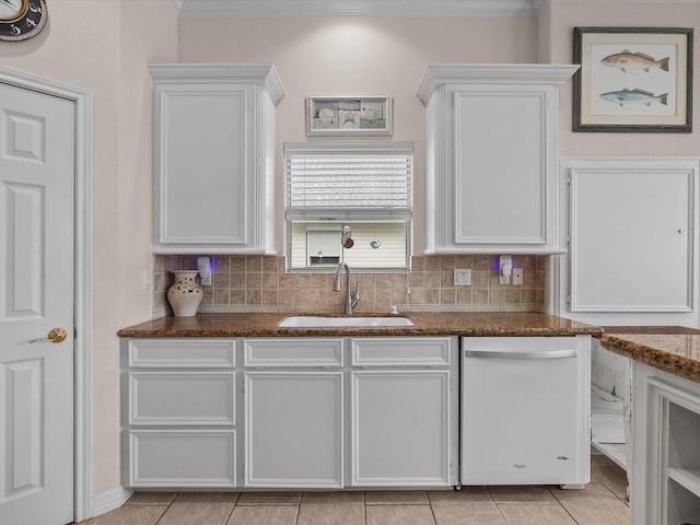 502 Westerly Dr, Tiki Island, TX 77554 - kitchen featuring a sink, white dishwasher, crown molding, white cabinets, and decorative backsplash