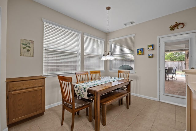 2615 Crystal Falls Dr, Pearland, TX 77584 - dining space with a chandelier, light tile patterned floors, and baseboards