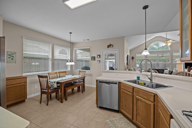 2615 Crystal Falls Dr, Pearland, TX 77584 - kitchen with stainless steel appliances, a sink, baseboards, light tile patterned floors, and lofted ceiling