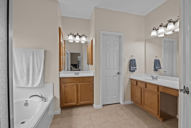 2615 Crystal Falls Dr, Pearland, TX 77584 - bathroom with tile patterned flooring, a bath, two vanities, and baseboards