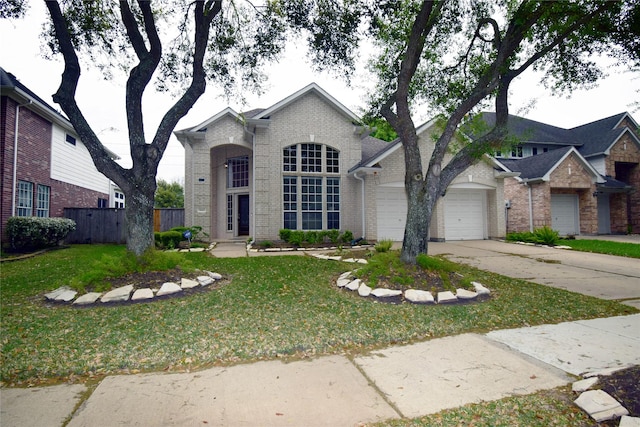5810 Brook Bend Dr, Sugar Land, TX 77479 - view of front of property with brick siding, a garage, and driveway