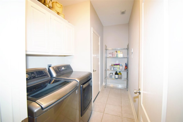 5810 Brook Bend Dr, Sugar Land, TX 77479 - laundry room featuring cabinet space, independent washer and dryer, and light tile patterned flooring