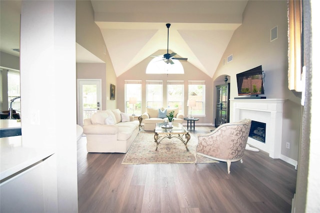 5810 Brook Bend Dr, Sugar Land, TX 77479 - living room featuring ceiling fan, a fireplace, dark wood-style floors, healthy amount of natural light, and vaulted ceiling