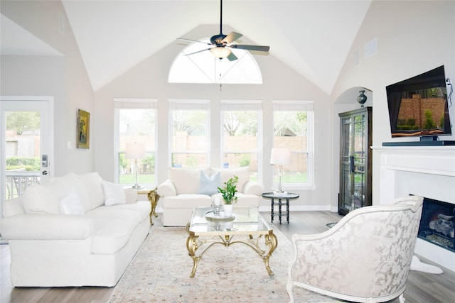 5810 Brook Bend Dr, Sugar Land, TX 77479 - living area featuring a ceiling fan, wood finished floors, healthy amount of natural light, and high vaulted ceiling