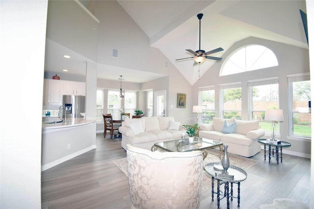 5810 Brook Bend Dr, Sugar Land, TX 77479 - living area featuring wood finished floors, high vaulted ceiling, ceiling fan, and recessed lighting