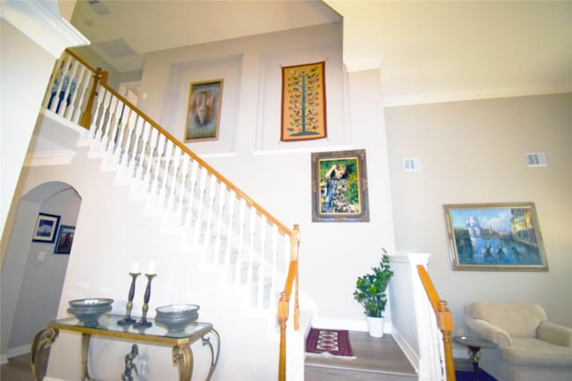 5810 Brook Bend Dr, Sugar Land, TX 77479 - stairway with arched walkways and wood finished floors