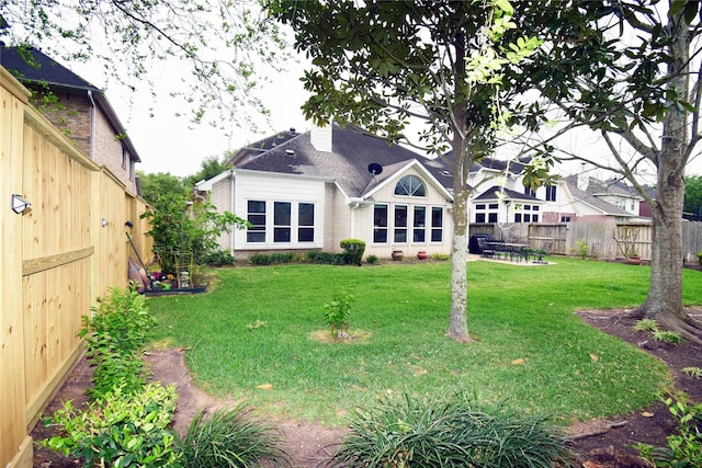 5810 Brook Bend Dr, Sugar Land, TX 77479 - back of property with brick siding and a chimney