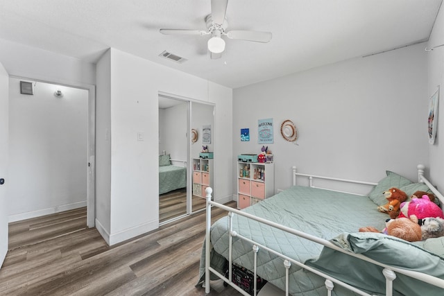 10023 Ash Fork Dr, Houston, TX 77064 - bedroom with wood finished floors, ceiling fan, baseboards, and a closet