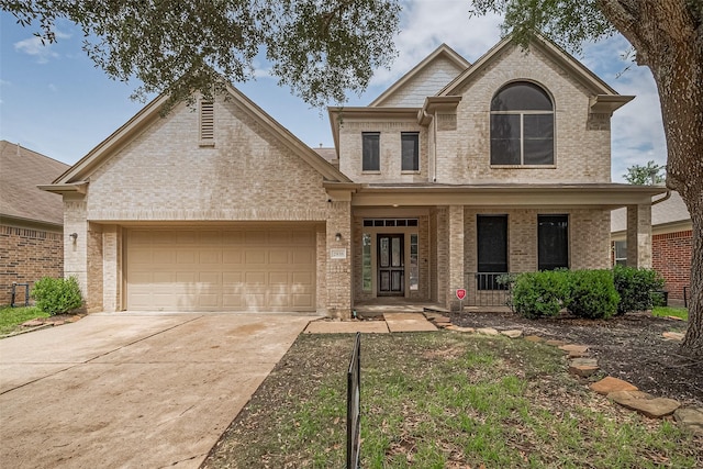 2938 Intrepid Elm St, Houston, TX 77084 - view of front of home with brick siding, a porch, a garage, and concrete driveway
