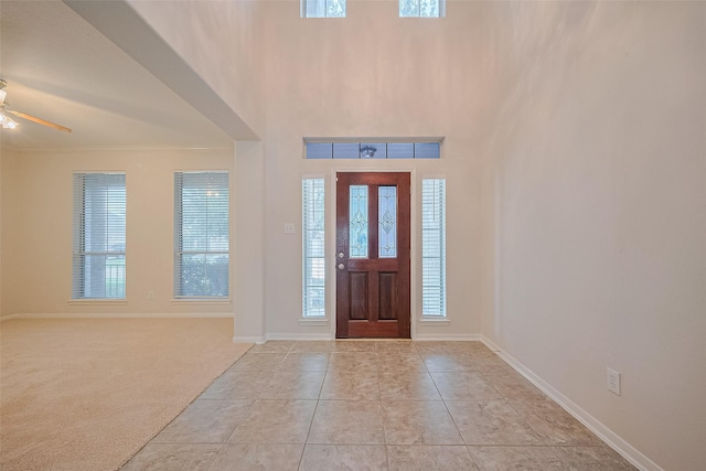 2938 Intrepid Elm St, Houston, TX 77084 - foyer featuring ceiling fan, baseboards, light tile patterned flooring, and crown molding